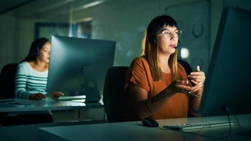 Contact center agent speaks on phone with customer Contact center agent speaks on phone with customer