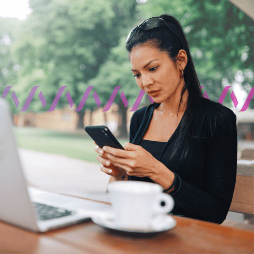 Photoillustration of a woman holding a cell phone with a laptop and a coffee cup in background