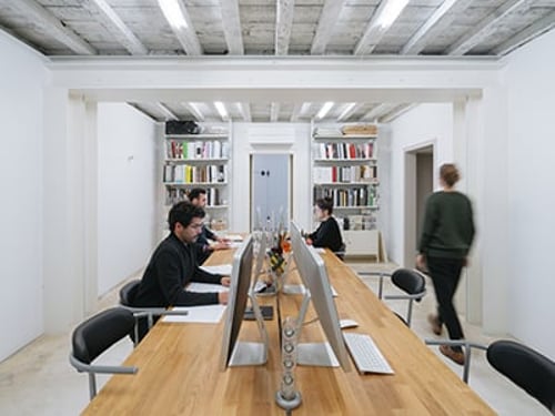 Woman walking in a modern office space.