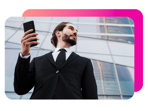 Image of a man with phone in a black suit
