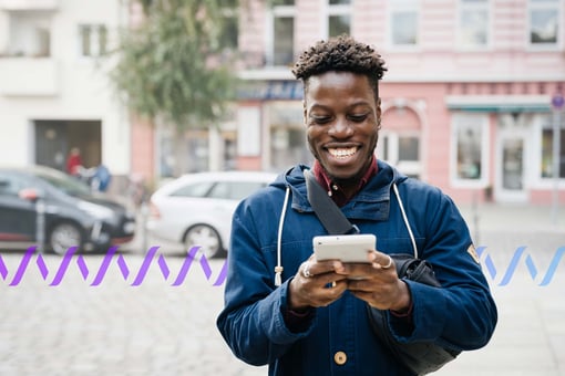 A man using a tablet phone outside in the street
