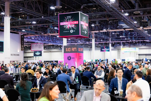 Image of previous Money 2020 event conference room filled with people networking 
