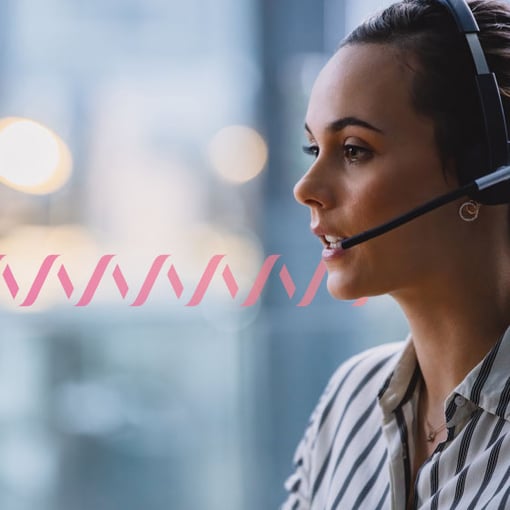 CC BYOC for CCaaS Blog Thumbnail Photo of a contact center agent speaking to a customer through her headset. The woman is in the foreground and the background is blurred. A series of small pink wave forms run across the frame, representing communication.