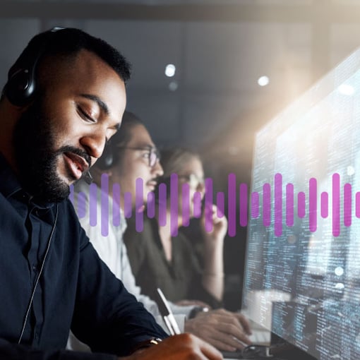 VBC Integrations Superpowers blog Man wearing a headset working in front of a computer screen displaying data, as a man and woman colleague work in the background.