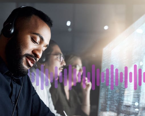 Integrations superpowers Man wearing a headset working in front of a computer screen displaying data, as a man and woman colleague work in the background.