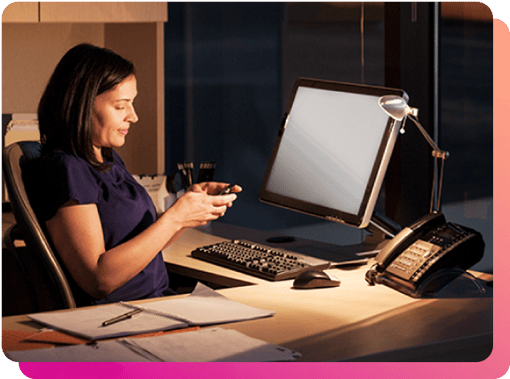 Woman flipping a call from her cellphone to desktop phone or computer, at night