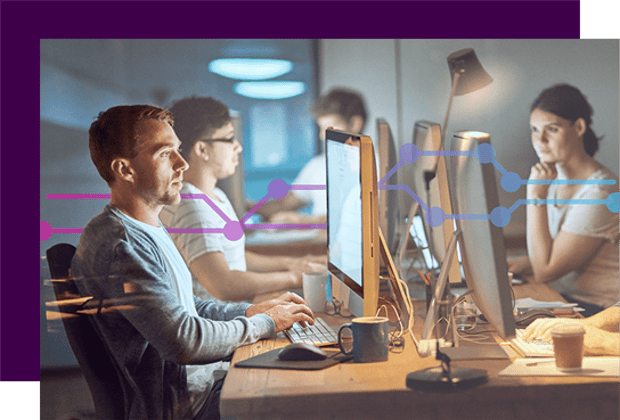 Shot of a group of young people using computers during a late night in a modern office
