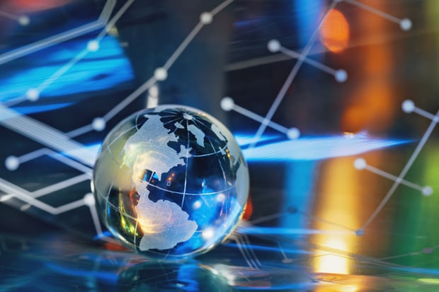 A crystal world globe on computer network background, illustrating digital sovereignty