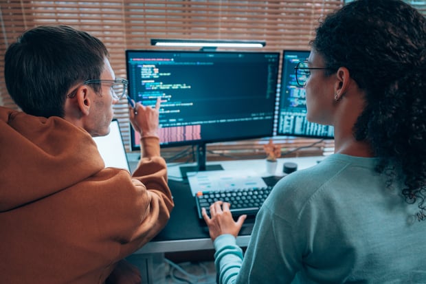 A programming team collaborates on software development, reflective of the collaboration between Vonage and Aduna
