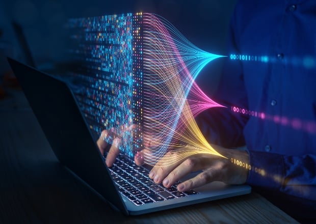 An abstract image of a person typing on a laptop, and the laptop is surrounded by digits and bits of code, illustrating an AI agent accessing a developer platform. 