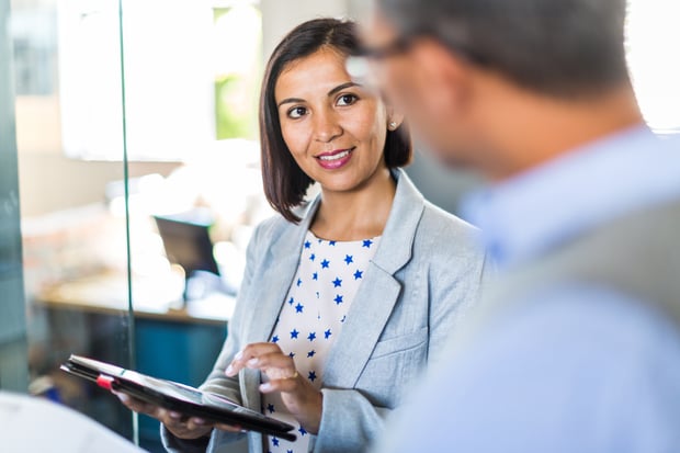 Two managers at a business talk about customer engagement and the communications layer.