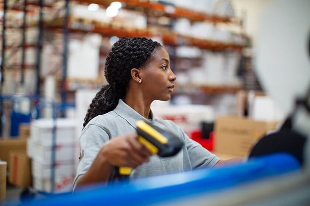 woman in warehouse scanning item