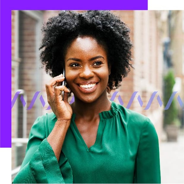 Apps Right Number Blog Header Photo of a smiling woman outdoors in a city setting talking into a cell phone.