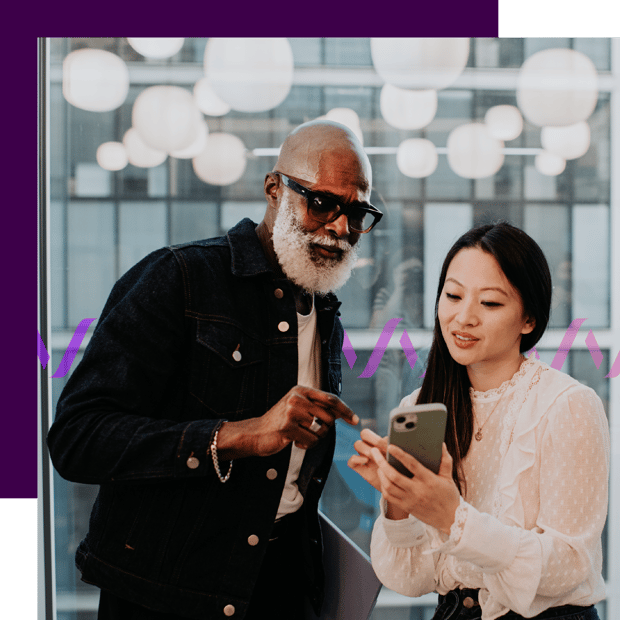 Photoillustration of a Black man and an Asian woman reviewing an RCS message on an iPhone