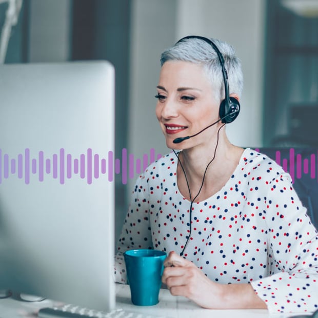 CC 5 Ways AI Improves Revenue Blog Header Photo of contact center agent talking to a customer through her headset and looking at her computer screen. Running across the frame are a series of vertical purple lines representing communication.