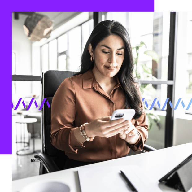Photo of a woman sitting in an office setting texting or talking on her cell phone. In the background, a series of purple-to-blue wave forms runs across the frame.