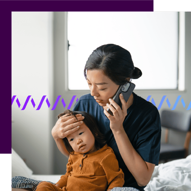 Photo of a mother sitting on a bed with her child. She has her hand on the child's forehead, checking for a fever, while talking on her cell phone. In the background, a series of small purple waveforms runs across the frame.