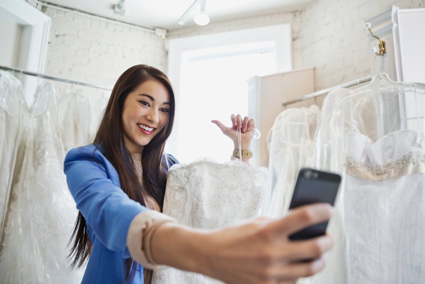 image of woman taking a selfie with a wedding dress, to depict live video shopping