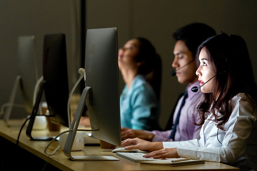 Call center with agents at computer monitors