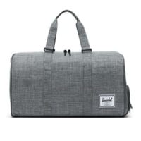 Grey Herschel duffle bag with a hand strap for carrying 