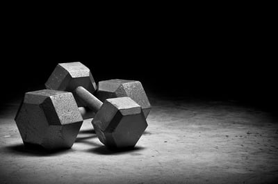 Weight lifting Dumbbells isolated on grunge surface.