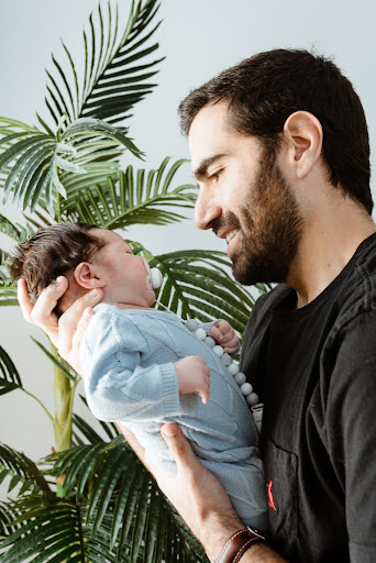 Vonage employee Pedro Baltazar holding a baby