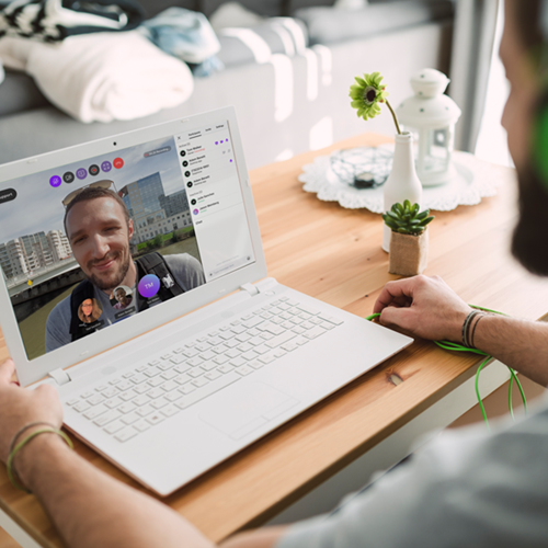 Solve with Video Man video chatting on his laptop with another individual
