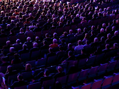 Seated audience in a theater.