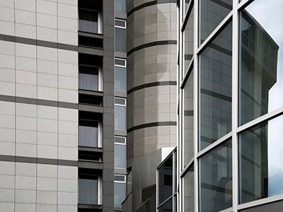 Modern Architecture Closeup Smiling woman on the street looking at her phone