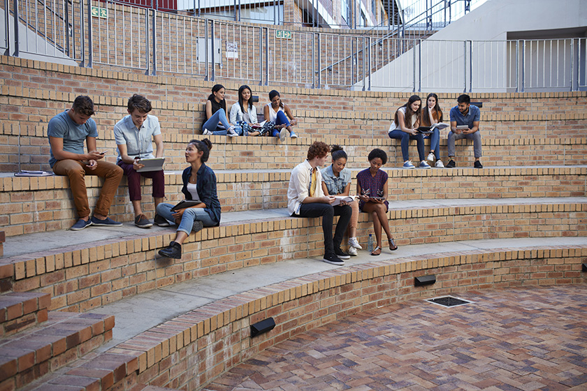 658984259 Students studying in groups outdoors on campus