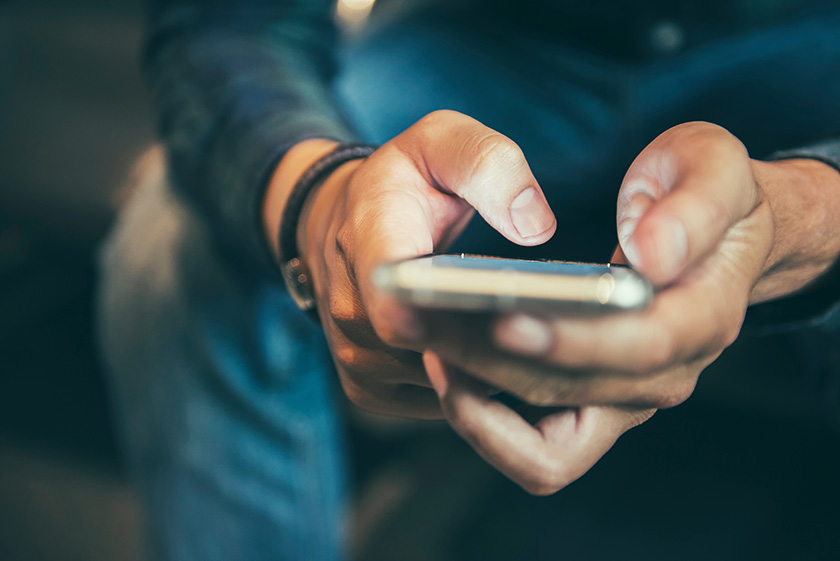 938786704 Person texting on mobile phone